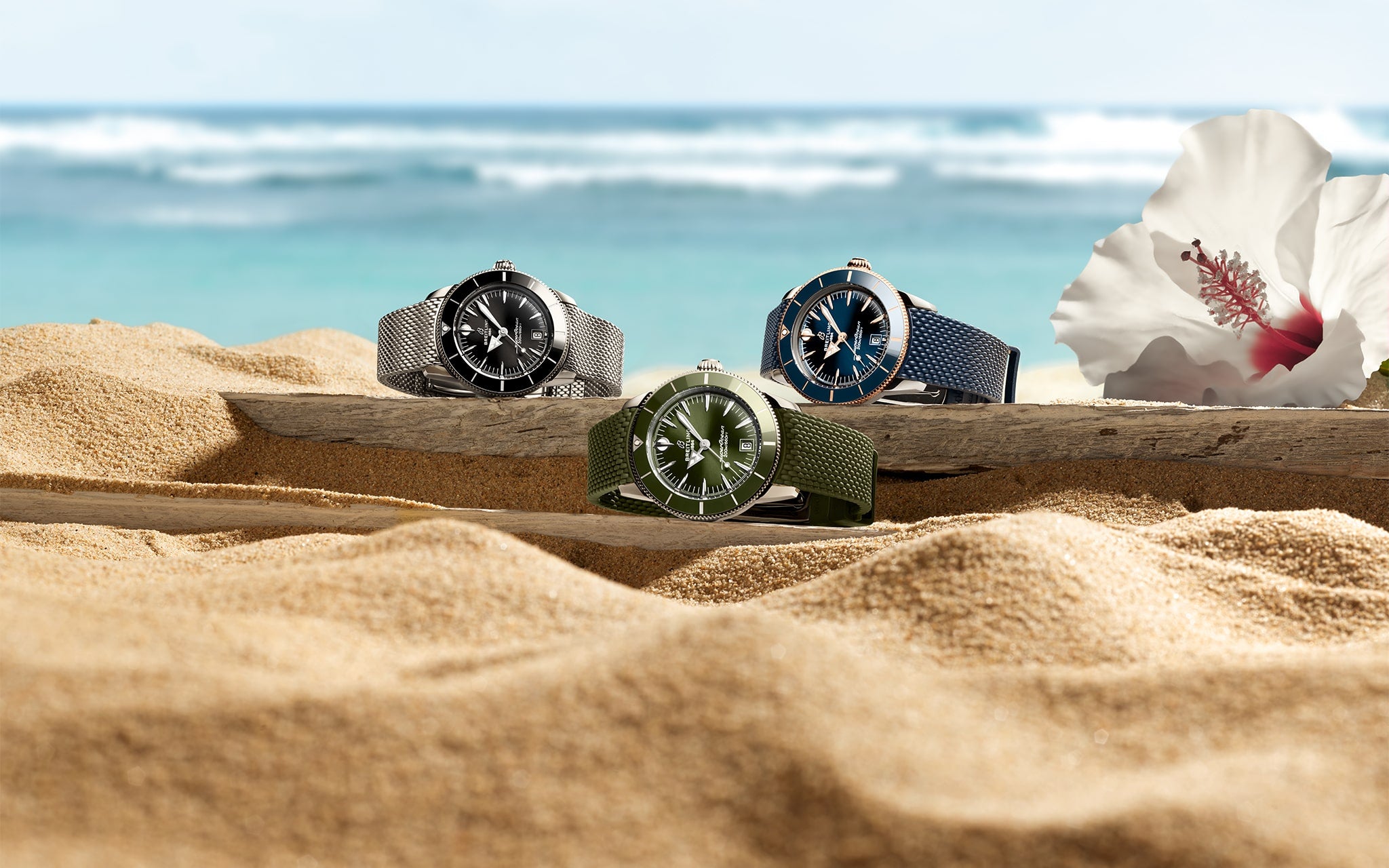 Three watches on a sandy surface with a beach background