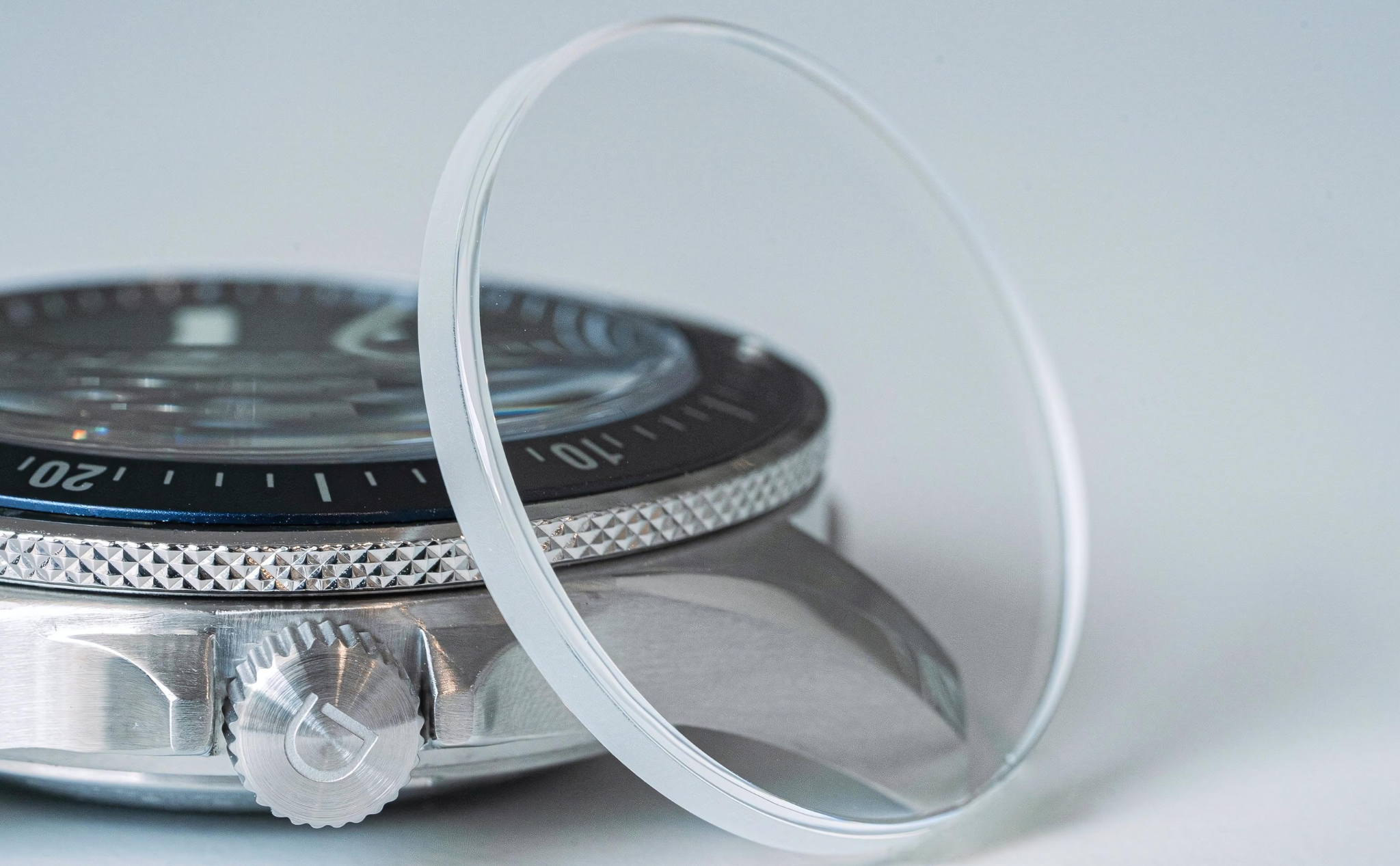 Different types of watch crystals on a black table